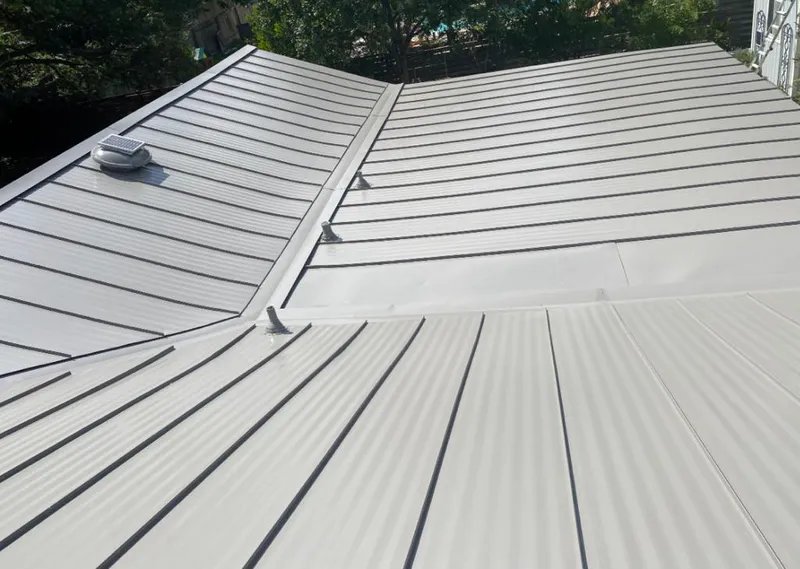 Solar attic fan installed on a metal roof for Roof Ventilation in South Charleston